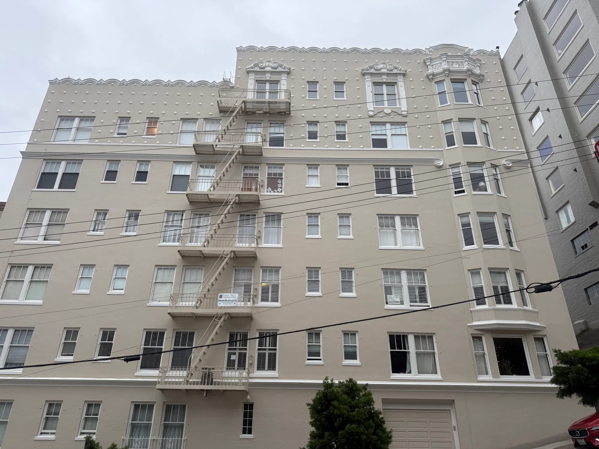 Full-building exterior repaint of a large San Francisco apartment building with ornate cornice work by Tara Pro Painting