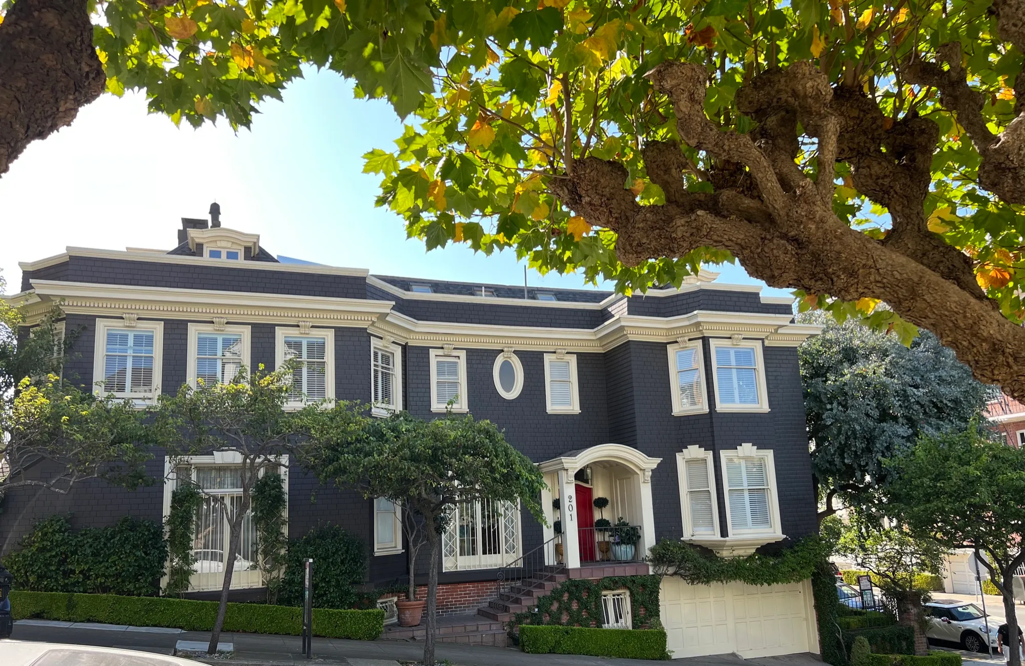 Charcoal-gray San Francisco home with fresh cream trim and red front door, repainted by Tara Pro Painting